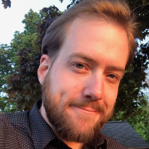Photo of Mike Yavorsky smiling in front of trees